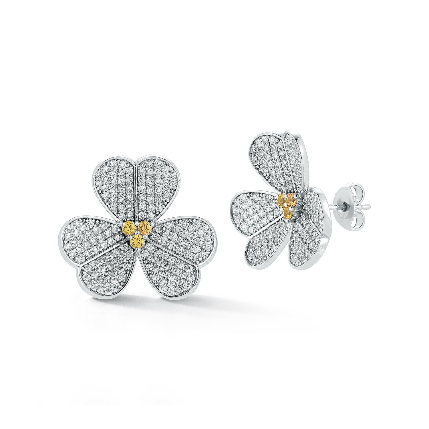 Flower-shaped earrings with diamond accents on a white background